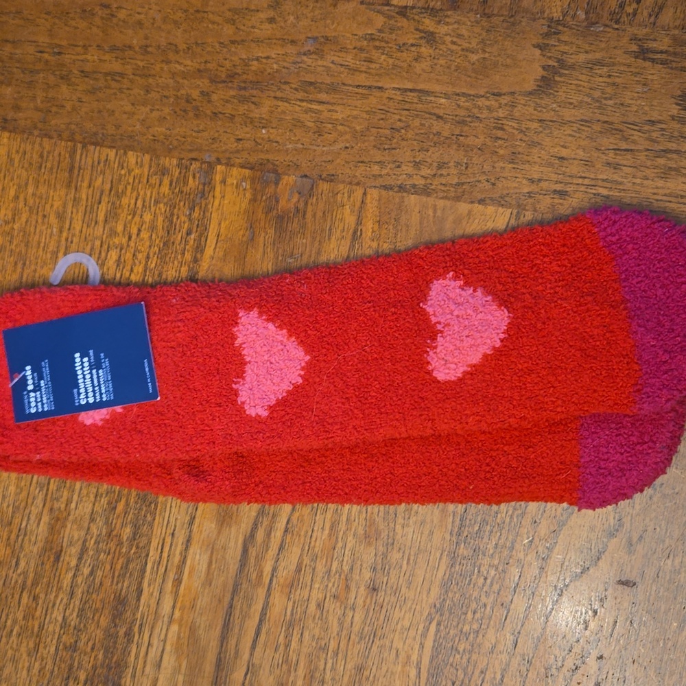 Red fuzzy socks with pink hearts